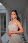 AQUA BLUE NET LEHENGA EMBELLISHED WITH SEQUINS,CUT DAANA AND A TOUCH OF MIRROR WORK