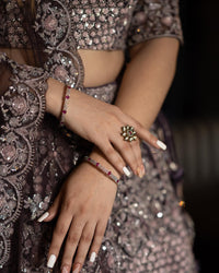 DARK LAVENDER NET FLORAL SEQUINS LEHENGA WITH ALL OVER FRENCH KNOTS AND RESHAM HANDWORK