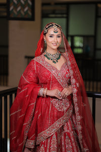 RED RAW SILK BRIDAL LEHENGA WITH ALL OVER ZARDOSI WORK AND THREAD OF MULTICOLOURED FLOWERS