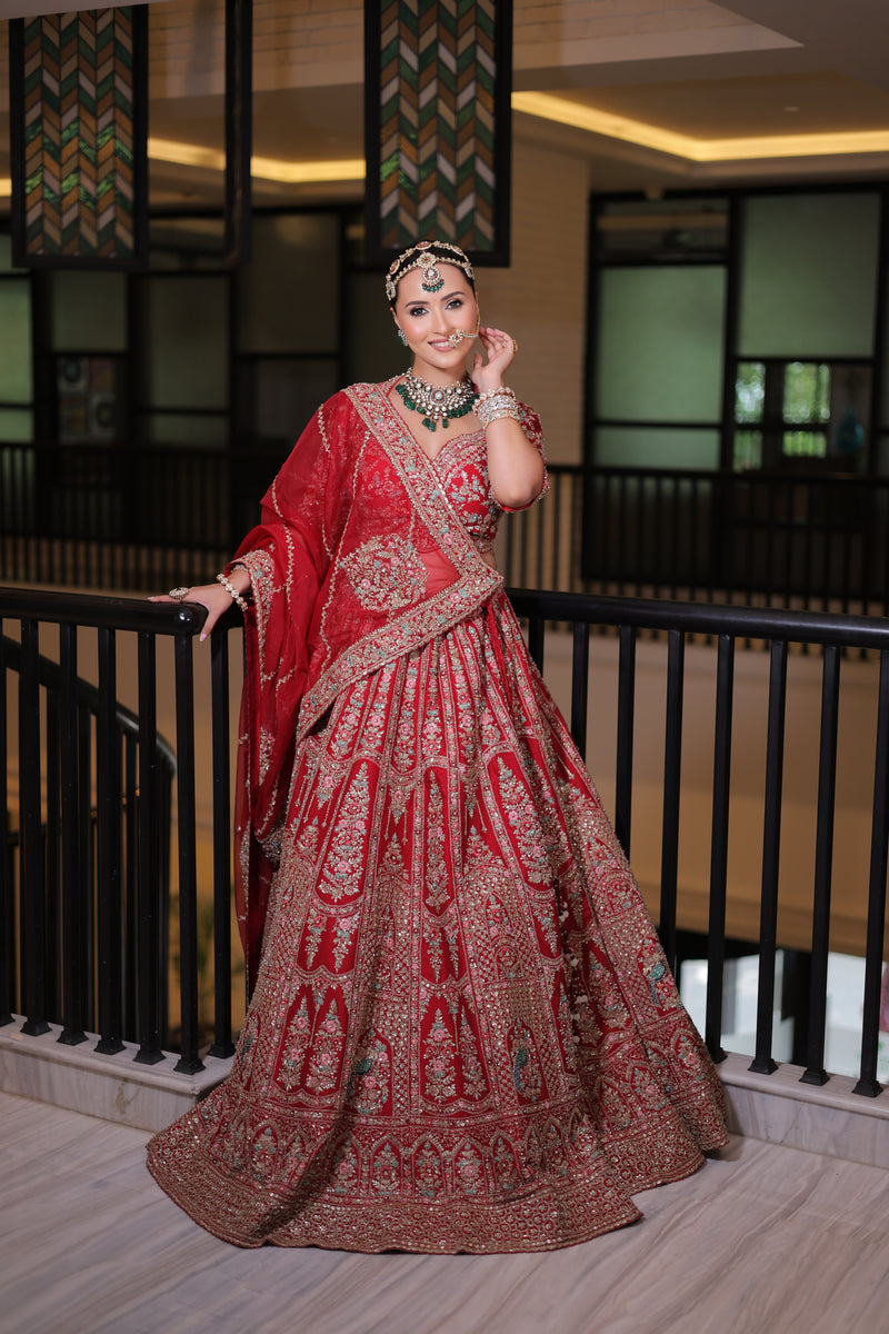 RED RAW SILK BRIDAL LEHENGA WITH ALL OVER ZARDOSI WORK AND THREAD OF MULTICOLOURED FLOWERS
